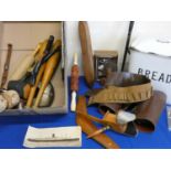 An enamel bread bin and a box of wood ware including, leather gaiters, boomerang, pair of swinging