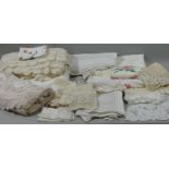 A hand crocheted single bed spread, a quantity of table cloths, bedsheets and line.