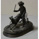A bronzed figure of a boy with stick & hoop and dog.