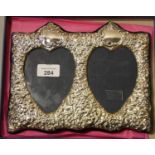 A silver embossed double heart photograph frame, boxed