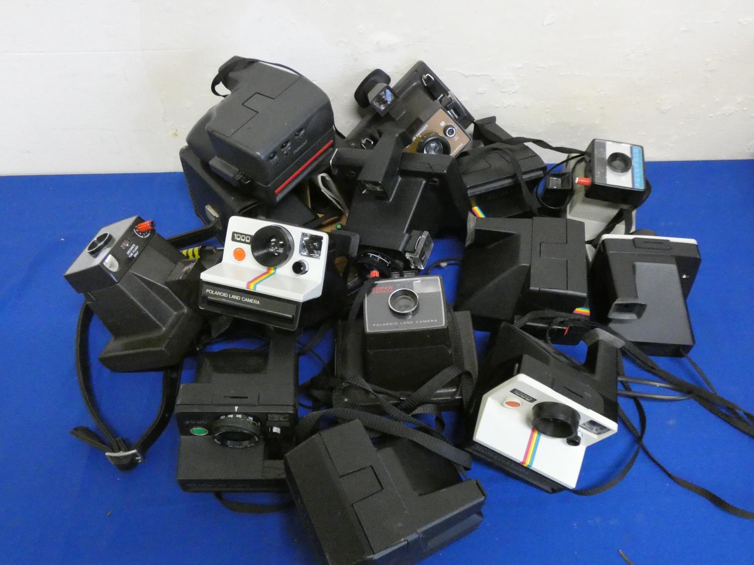 A collection of Polaroid and Instamatic cameras.