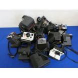 A collection of Polaroid and Instamatic cameras.