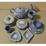 A Wedgwood jasperware tea pot, trio, two lidded boxes and other pieces.