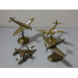 Three brass models of aircrafts on stands, together with another free standing model. (4)