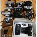 A collection of cameras to include, Cosina SLR Zoom kit, cased, Zenit 12xP, E, II, B, 3M and