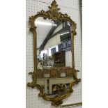 A gilt scrolling framed wall mirror. 100cm long.