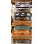 A small crocodile suitcase with padded interior and 8 other suitcases and briefcases (9).