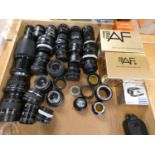 A collection of camera lenses, including makers Prakticar, Vivitar, Pentax, together with camera