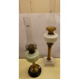 Two brass oil lamps with coloured glass reservoirs and chimneys. (2)