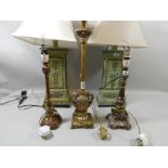 A pair classically styed column table lamps, each painted in a different shade of green with cream