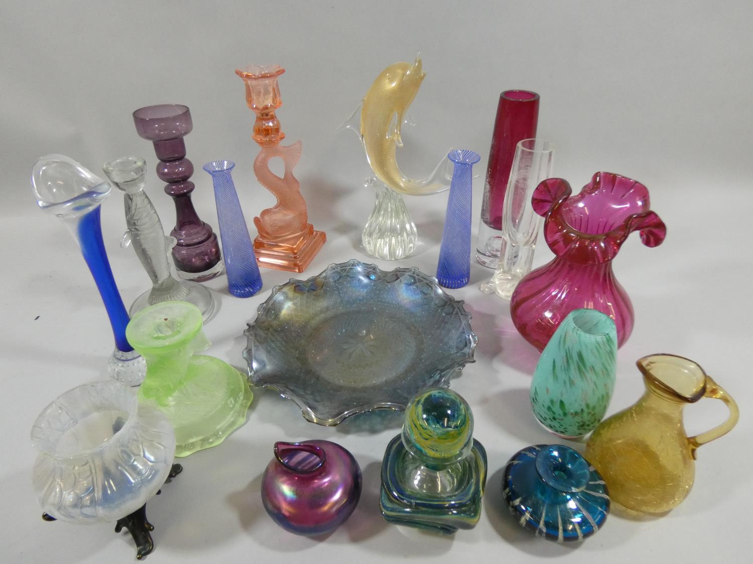 A Loetz style glass vase, two press moulded fish candlesticks and other glassware.