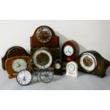An oak cased 'Napoleon Hat' style mantle clock, together with other oak and mahogany cased mantle