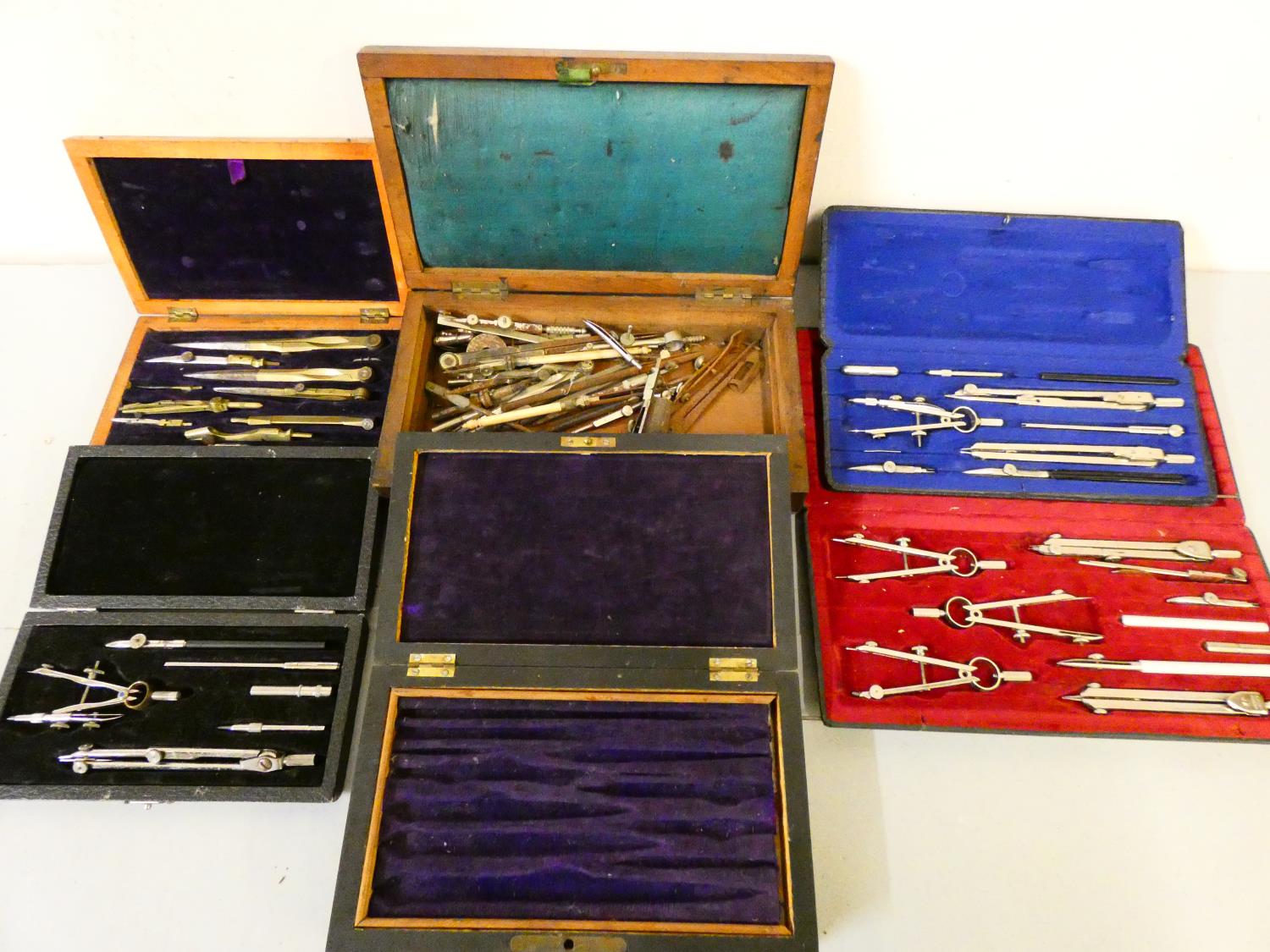 Four cased sets of technical drawing instruments and two boxes with loose pieces.