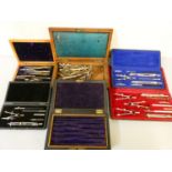 Four cased sets of technical drawing instruments and two boxes with loose pieces.