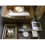 A collection of mantle clocks, carriage, and travel clocks, including a figurative brass table clock