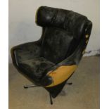 A child's wing back swivel armchair, in the style of G Plan chair, in need of restoration.
