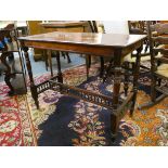 An Edwardian mahogany side table, raised on turned supports, with pierced stretchers, 90 x 44 cm and