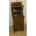 An Edwardian mahogany and boxwood strung coal purdonium, with a raised mirror back beneath an