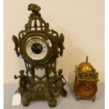 A cast gilt metal mantle clock, the base with seated male and female figures, 36 cm tall, together