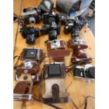 A collection of cameras to include, Praktica MTL5, Canon F-1 ,EOS 500, EOS 650, Viogilander,