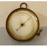 A brass cased circular holosteric barometer. 12.5 cm diameter.