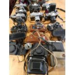 A collection of cameras and camera bodies, including Minolta SRT 101, XG2, Sr1, X300, Hi Matic7,