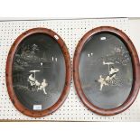 A pair of oval Japanese lacquered panels with ricksaw decoration, inlaid with bone and mother of