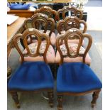 A Victorian mahogany set of 8 serpentine front balloon back dining chairs with turned tapering legs,