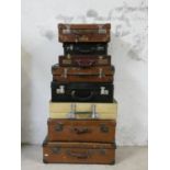 A collection of 8 suitcases including 2 with travel labels (8).