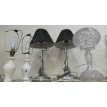 A cut glass table lamp together with two alabaster table lamps and a pair of stainless steel table