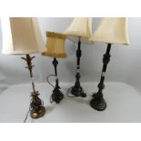 A pair of mottled brown table lamps with beige shades. 84cm tall, together with two other lamps. (4)
