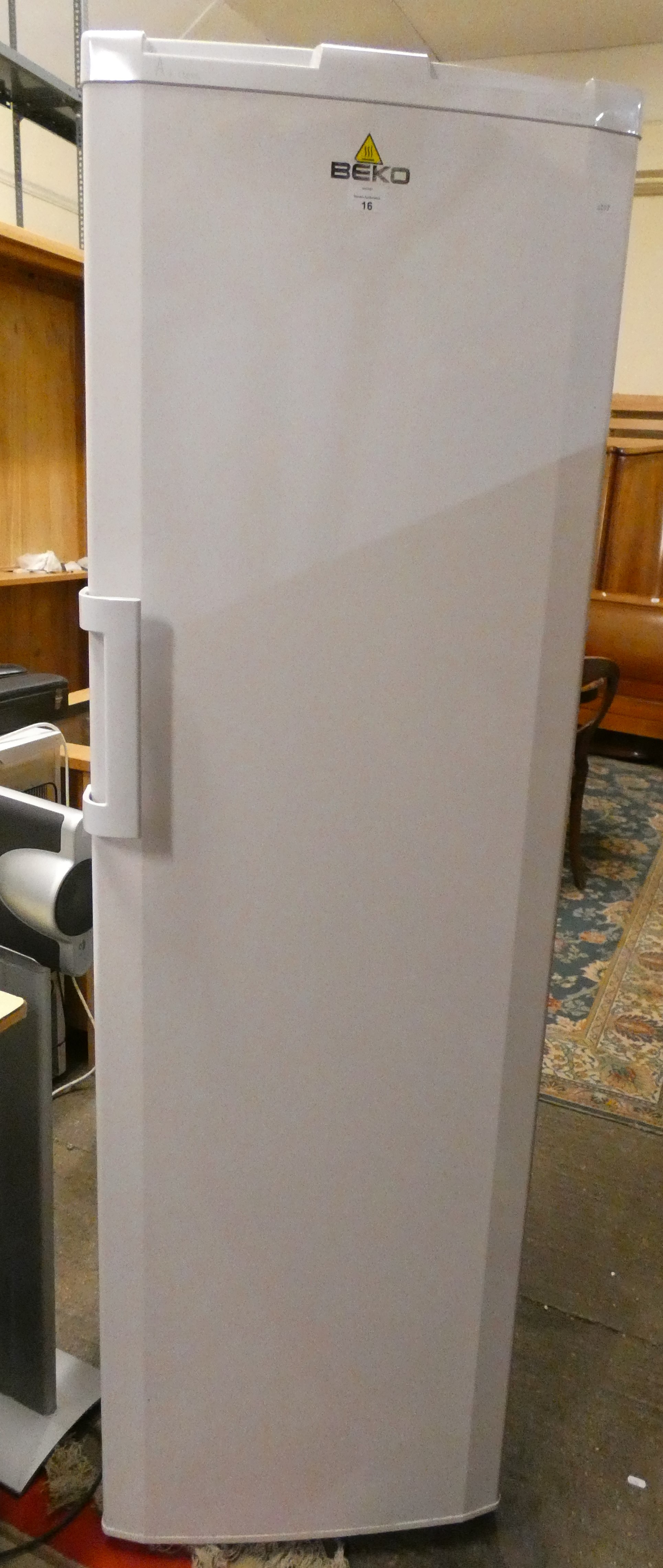 A Beko free standing freezer 178 cm tall 54 cm wide.