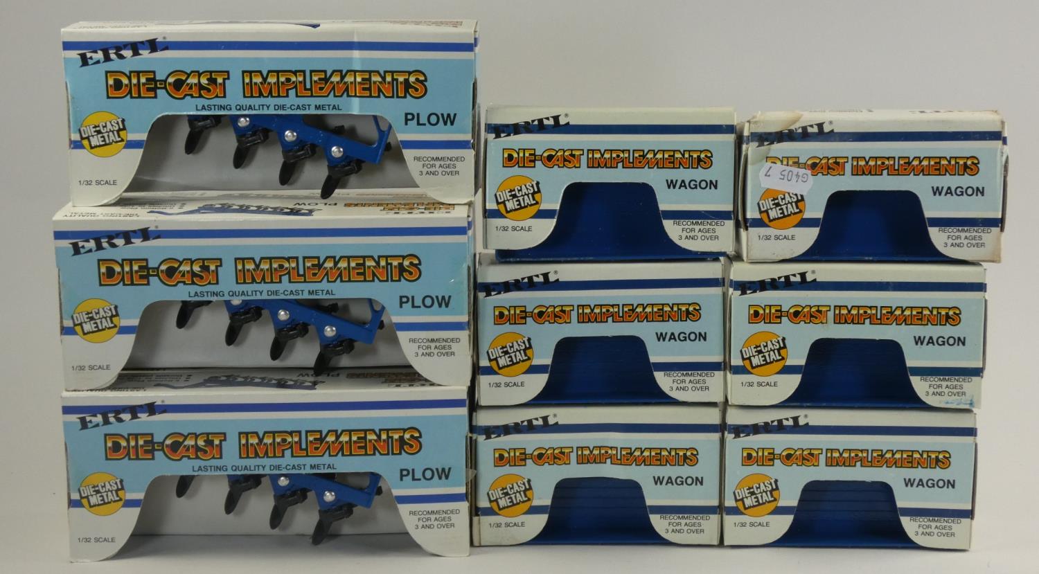 A large collection of boxed of Ertl die-cast machinery implements. including- plows and waggons