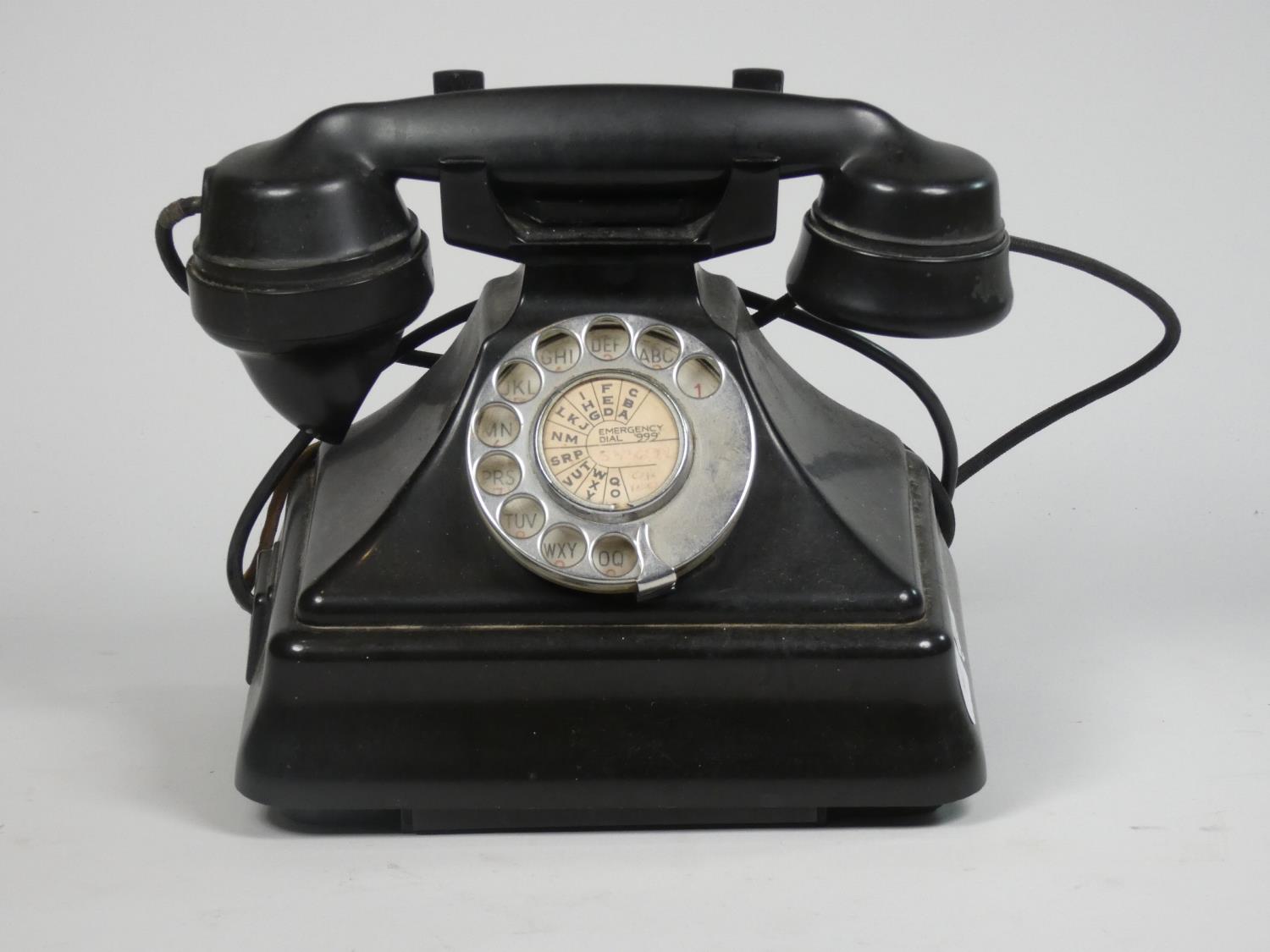 An early black bakerlite telephone.