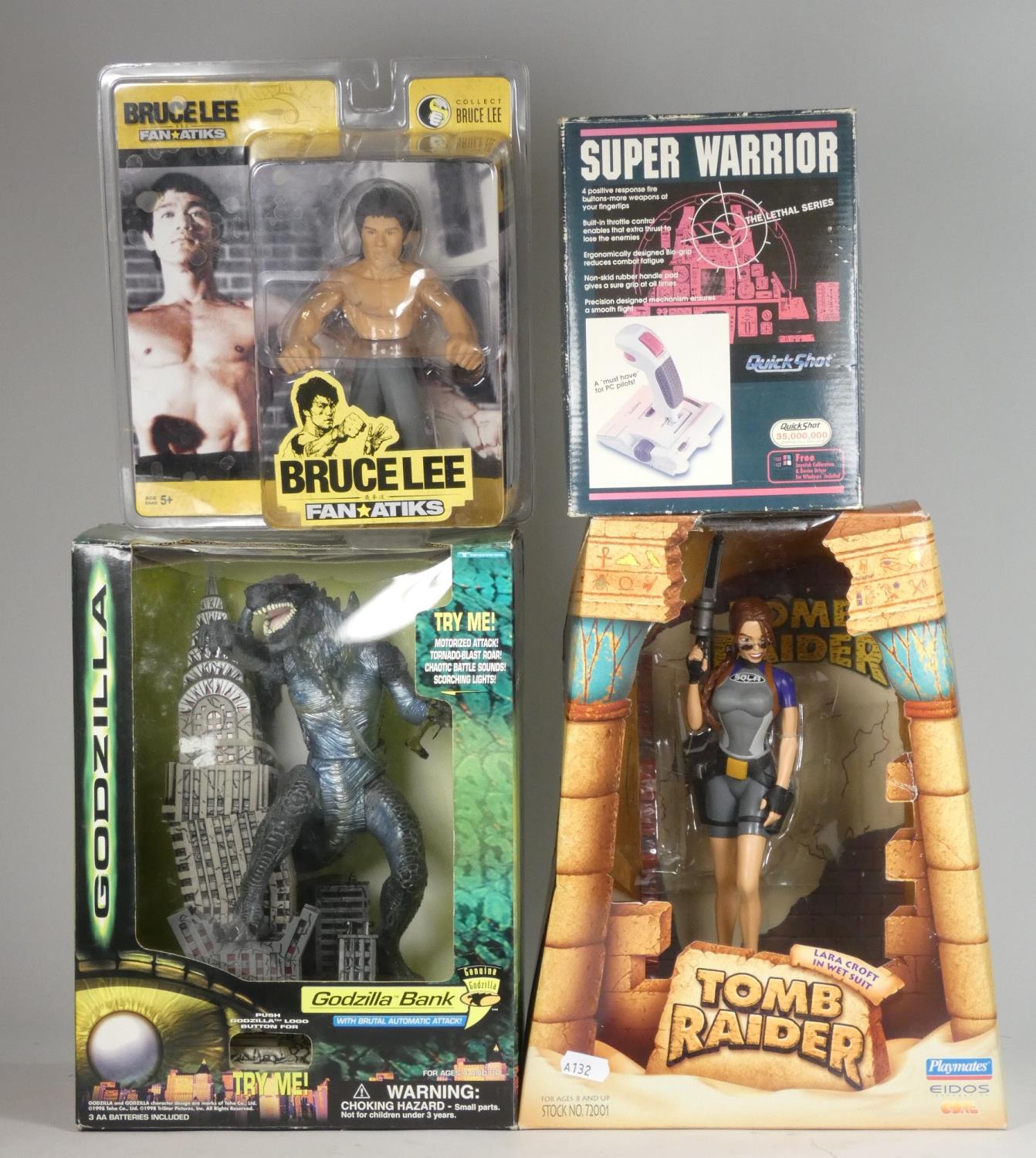 A Godzilla money bank, together with a Playmates Tomb Raider figure, a Bruce Lee figure, Quick