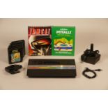 Atari 2600 console with power supply, TV lead and joystick including seven sames such as- PacMan and