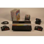 Boxed Atari 7800 console, power supply unit, two mini stick controllers, TV lead including nine