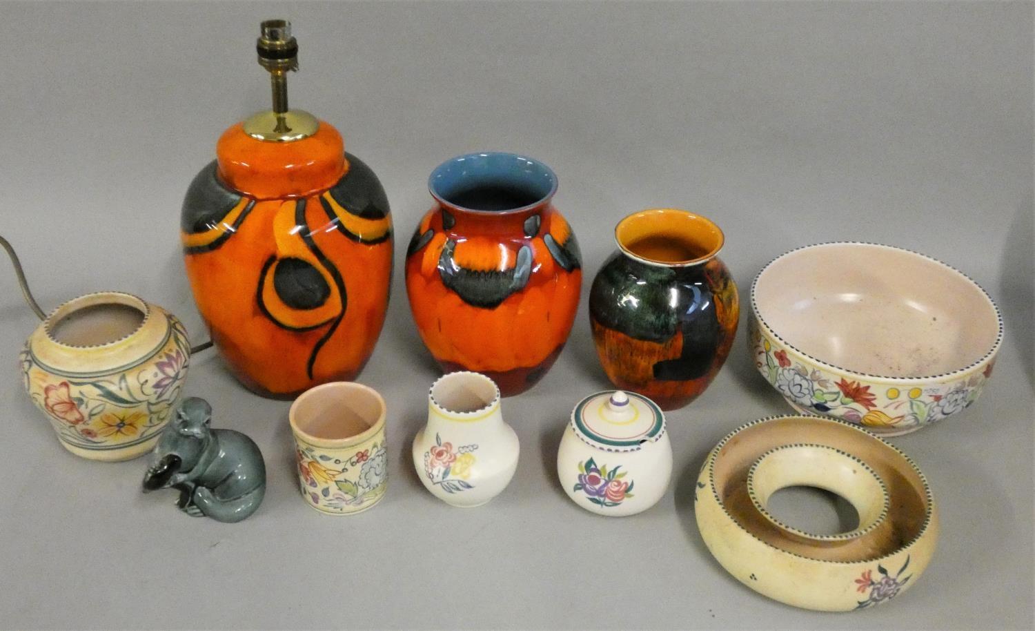 A collection of Poole pottery, including a standard lamp, various vases, model of a seal and other