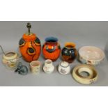 A collection of Poole pottery, including a standard lamp, various vases, model of a seal and other