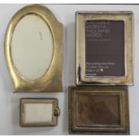 A silver photograph frame, Birmingham 1938, of shaped form, 19 x 13 cm and three other frames.