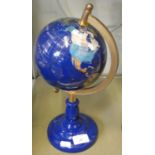 A brass mounted globe on blue ceramic base 33cm tall
