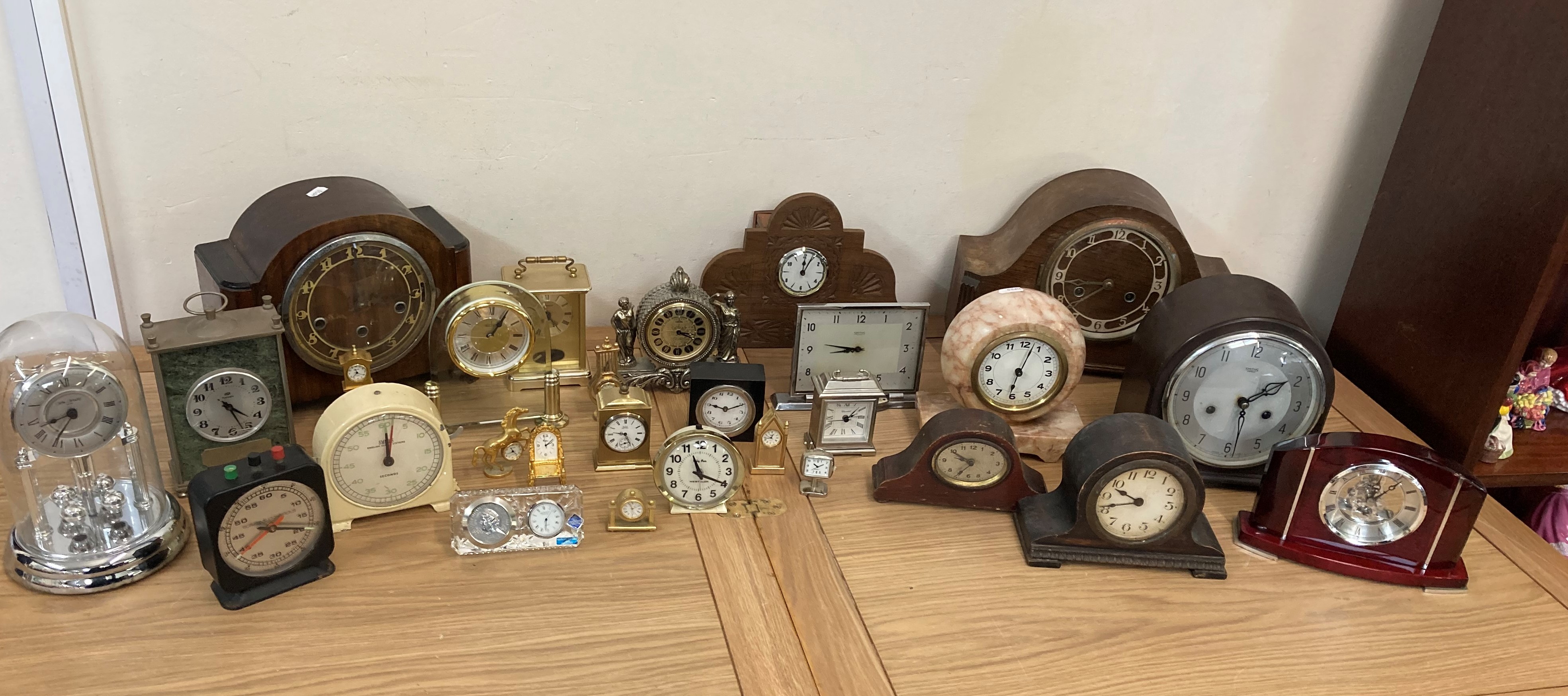 2 boxes of carriage, mantle and dome clocks including a small box of novelty clocks.