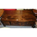 A hardwood low coffee table, with four drawers to each side, 57 x 121cm