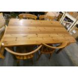 A pine kitchen table, 90 x 155cm and a set of 4 chairs