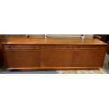 A low teak sideboard by Websters of Brighouse, comprising of 3 frieze drawers over 3 cupboards,