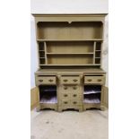A pale green painted pine dresser, the three shelf rack over three frieze drawers, over three