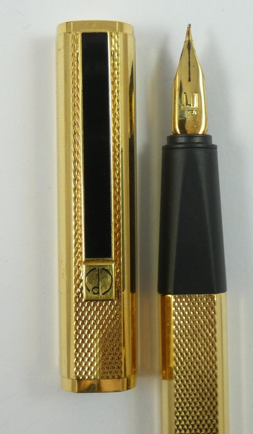 Dunhill, a gilt metal Gemline fountain pen, with engine turned body, 18K gold knib, warranty card, - Image 5 of 6