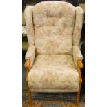 A pocket sprung button back armchair in beige floral fabric