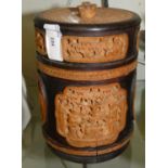 A wooden circular tea caddy, lead lined with carved wooden panels