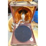 A cased portable wind up gramophone, RDC 31877, lacking pick up, with brass horn, together with